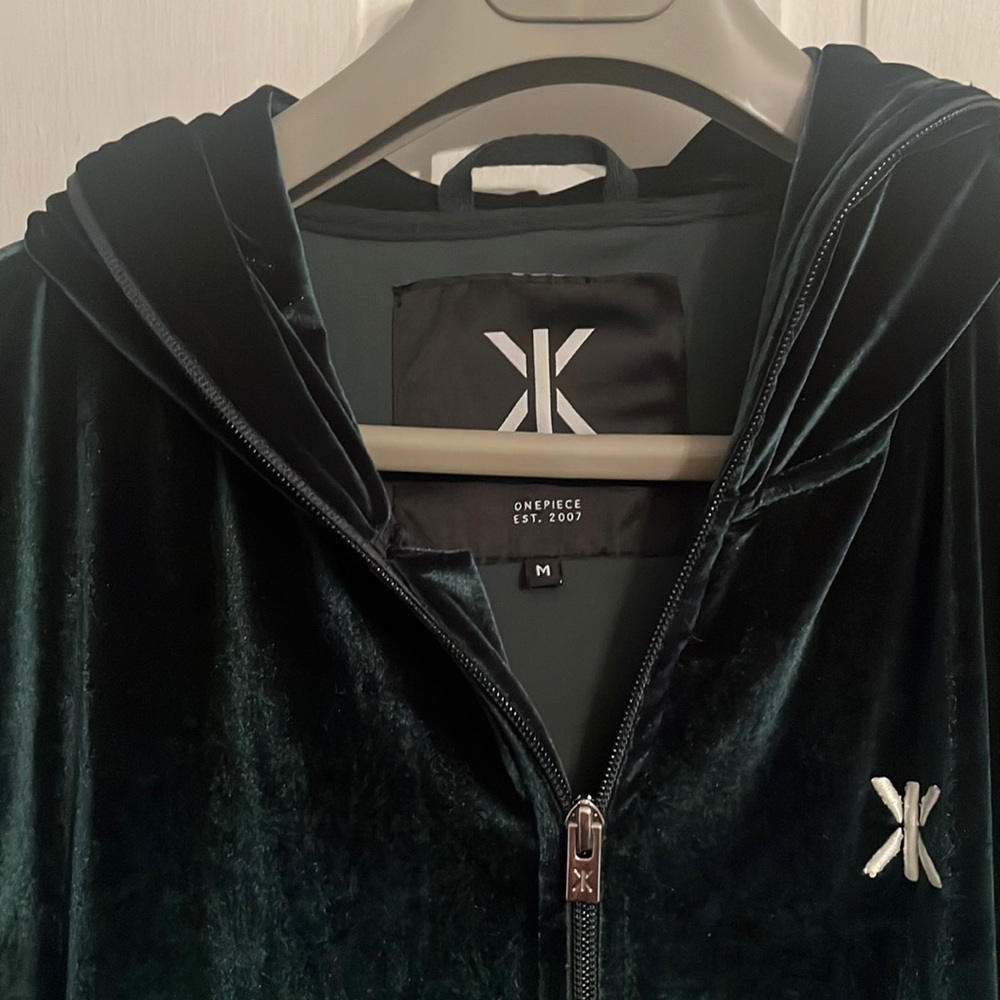 One piece dark emerald green onesie w/ zip close, hoodie, pockets. Size M unisex